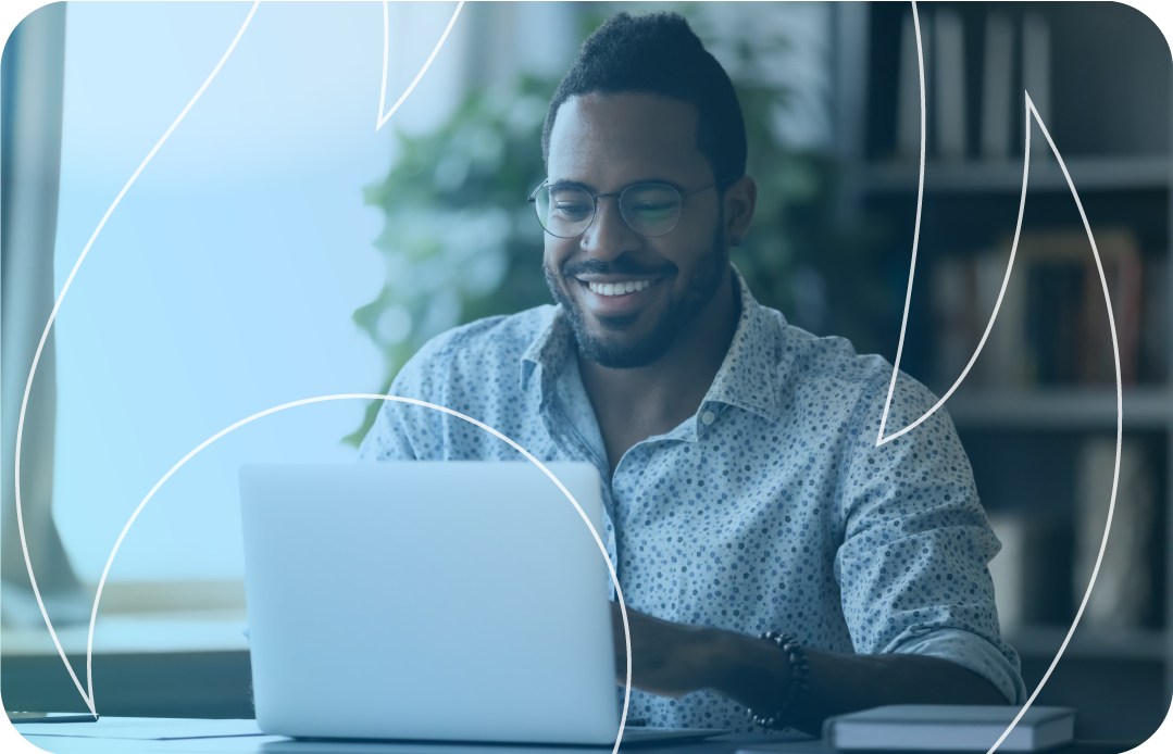 Man smiling looking at his laptop